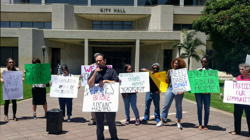 Reverend Francisco Garcia of the Uplift Inglewood Coalition speaks to protesters outside City Hall